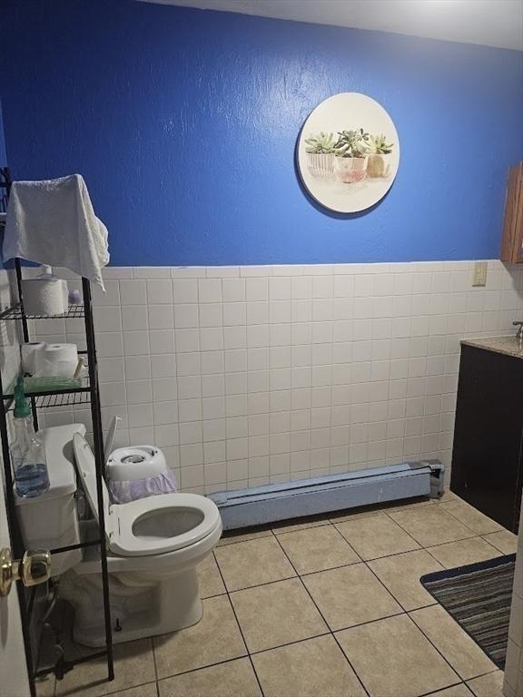 192 Chestnut St, Chelsea, MA 02150 - bathroom with tile walls, toilet, tile patterned floors, vanity, and baseboard heating