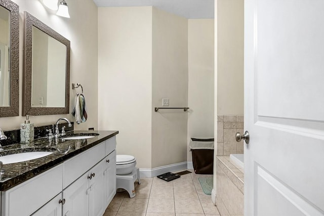 bathroom featuring vanity, tiled bath, tile patterned floors, and toilet