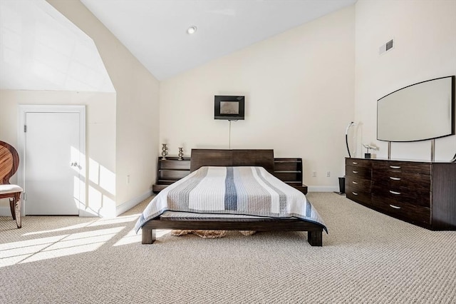 bedroom with light carpet and high vaulted ceiling