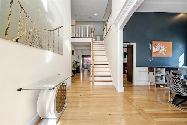 entrance foyer with a high ceiling and wood-type flooring