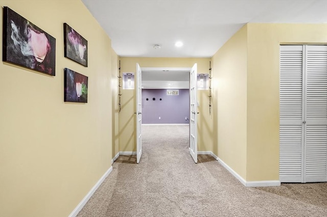 hallway featuring light colored carpet