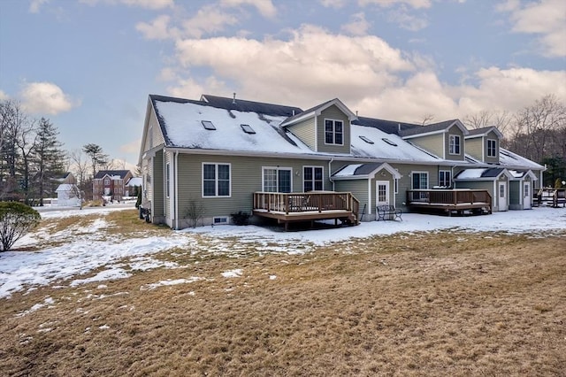 snow covered property with a deck