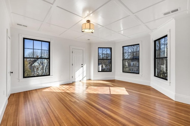 entrance foyer with a healthy amount of sunlight, light hardwood / wood-style flooring, and coffered ceiling