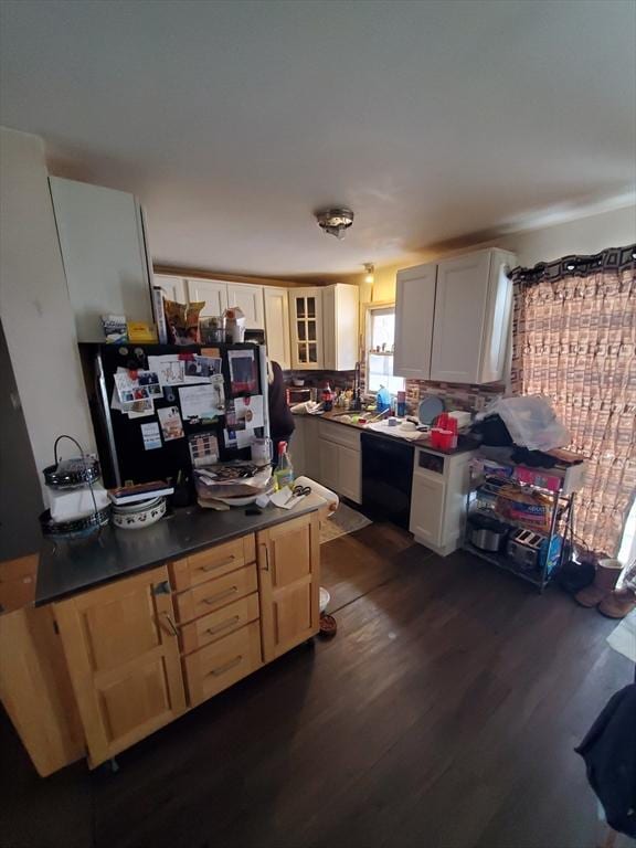 kitchen with dark hardwood / wood-style flooring and black appliances