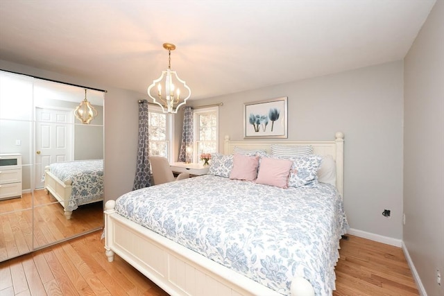 bedroom featuring wood-type flooring and a chandelier