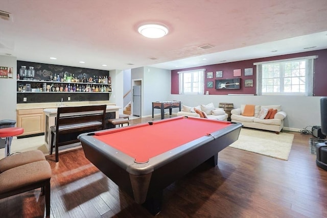 game room with indoor bar, dark wood-type flooring, and billiards