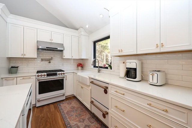 kitchen with white cabinetry, gas stove, lofted ceiling, and sink