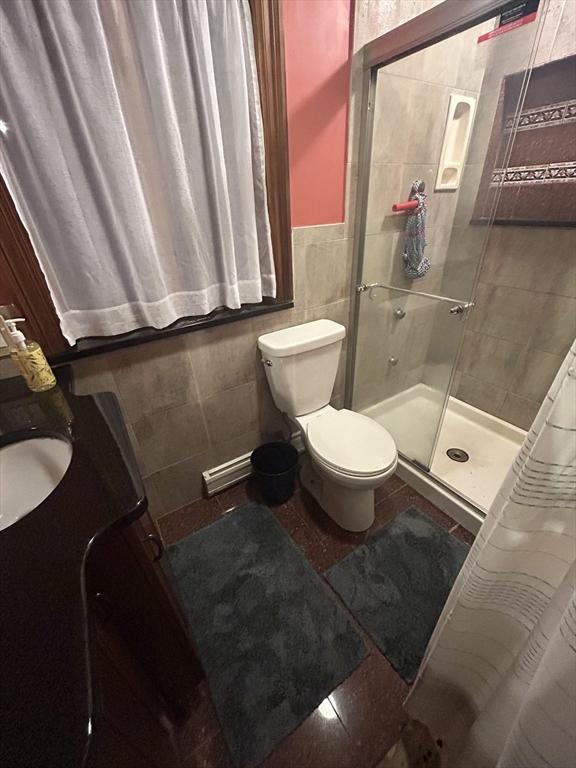 39R Spring St, Boston, MA 02132 - full bathroom featuring tile walls, a shower stall, vanity, and a wainscoted wall