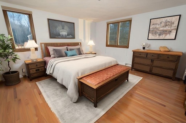 bedroom featuring light hardwood / wood-style floors and multiple windows