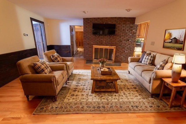 living room with a fireplace and light hardwood / wood-style floors