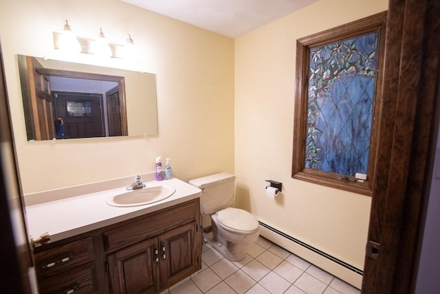 bathroom featuring tile patterned floors, vanity, toilet, and a baseboard heating unit