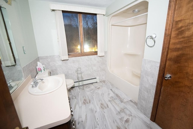 bathroom with toilet, sink, tile walls, and a baseboard heating unit