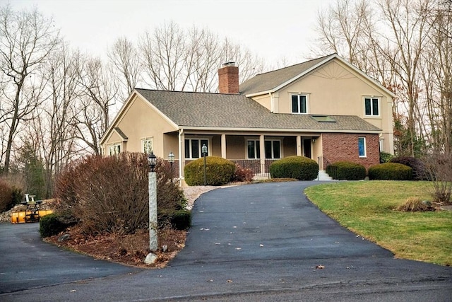 view of front property with a porch and a front lawn