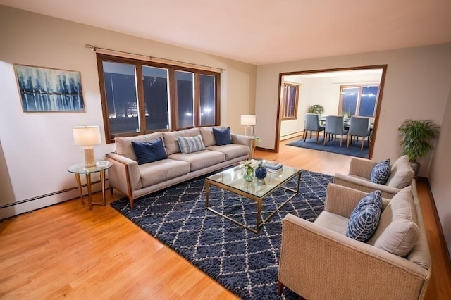 living room featuring hardwood / wood-style floors and a baseboard heating unit