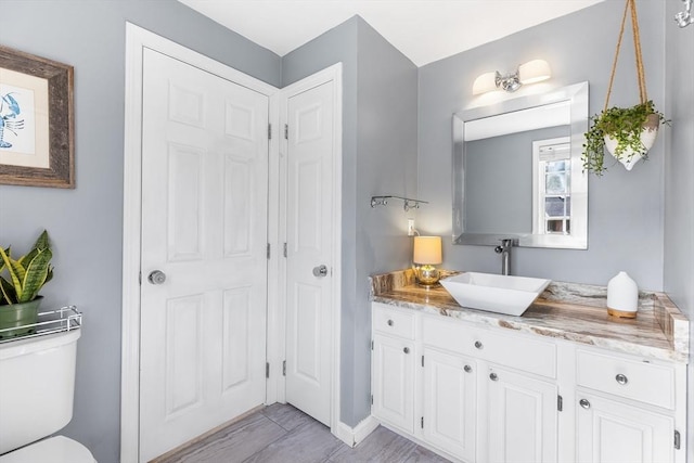 38 Thoreau Cir, Beverly, MA 01915 - bathroom featuring vanity, toilet, baseboards, and a closet