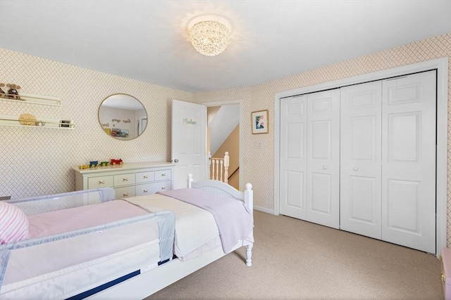 38 Thoreau Cir, Beverly, MA 01915 - bedroom with light colored carpet, wallpapered walls, baseboards, and a closet