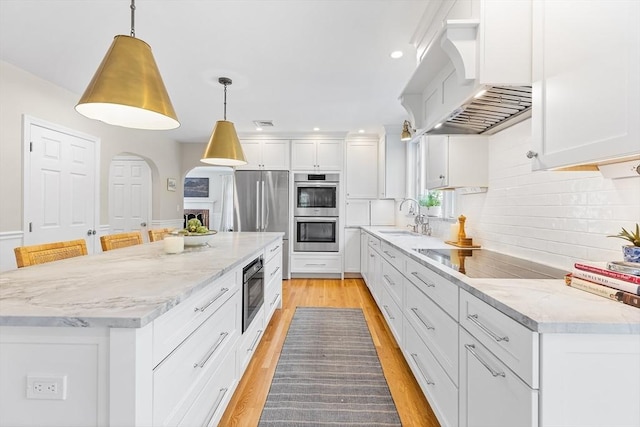38 Thoreau Cir, Beverly, MA 01915 - kitchen with appliances with stainless steel finishes, premium range hood, decorative backsplash, white cabinets, and recessed lighting