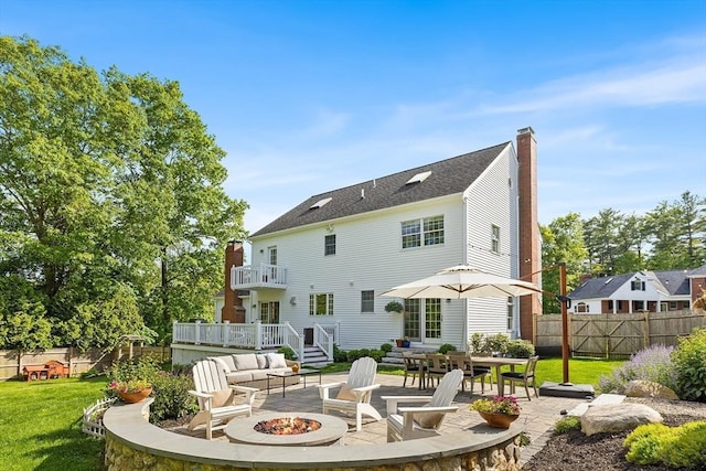 38 Thoreau Cir, Beverly, MA 01915 - rear view of property with an outdoor fire pit, a chimney, and a patio area