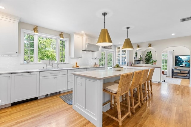 38 Thoreau Cir, Beverly, MA 01915 - kitchen with a sink, light wood-style flooring, decorative backsplash, white cabinets, and recessed lighting