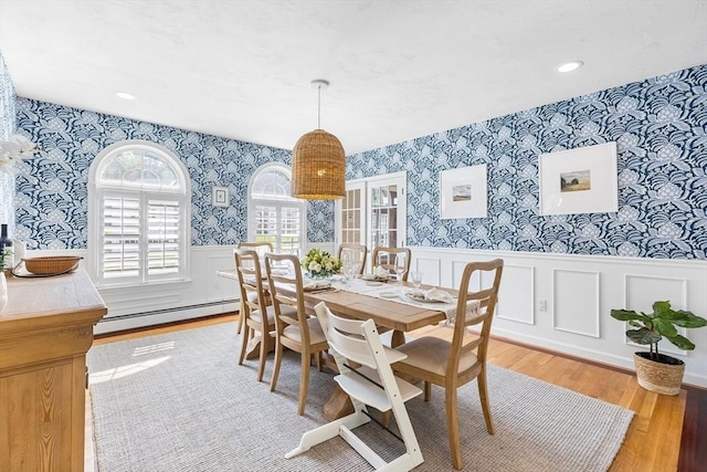 38 Thoreau Cir, Beverly, MA 01915 - dining room featuring wallpapered walls, a baseboard heating unit, healthy amount of natural light, wainscoting, and wood finished floors