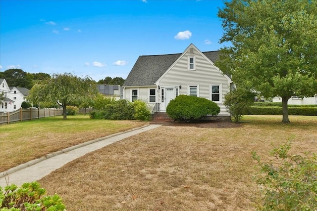 cape cod house with a front lawn