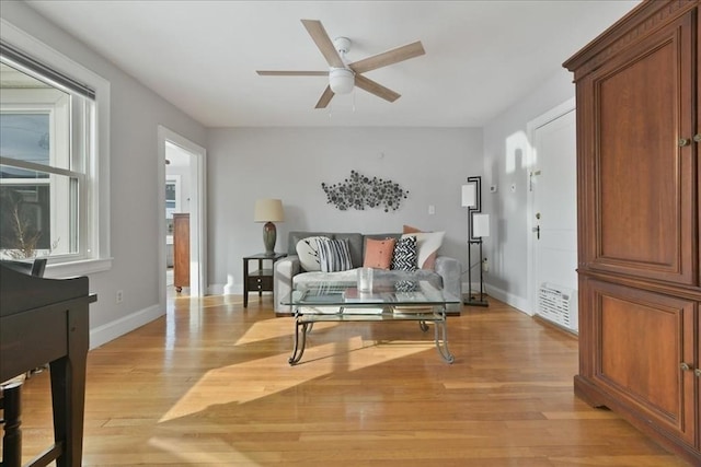 living room with ceiling fan and light wood-type flooring