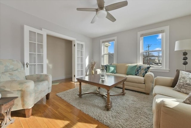 living room featuring wood-type flooring and ceiling fan