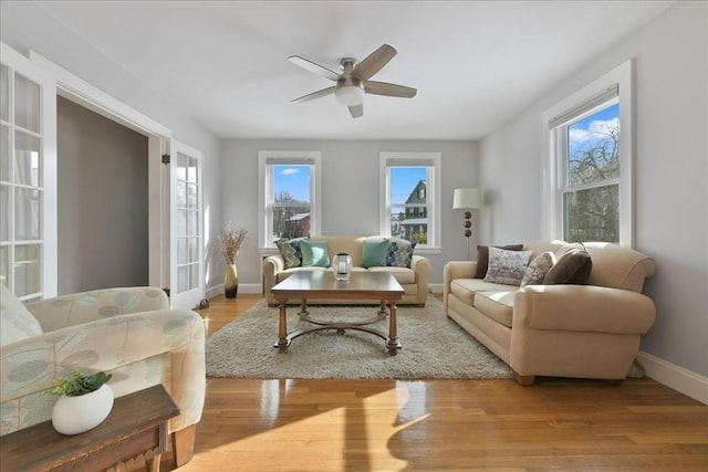 living room featuring ceiling fan and light hardwood / wood-style flooring