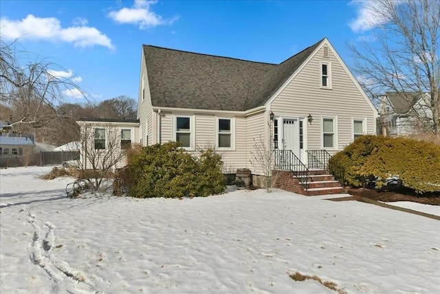 view of snow covered back of property