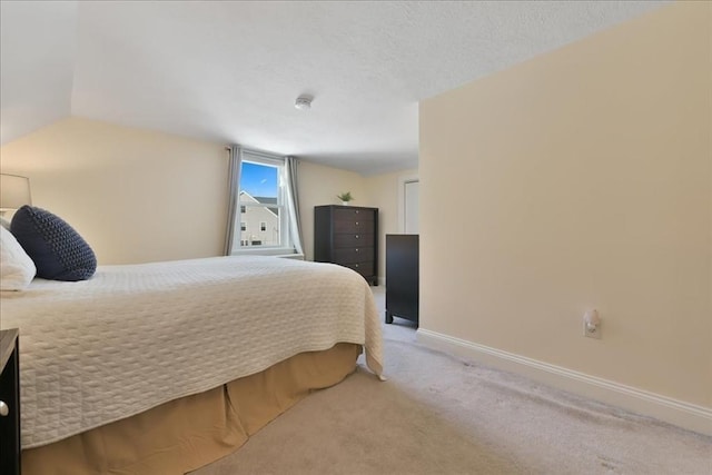 carpeted bedroom with vaulted ceiling