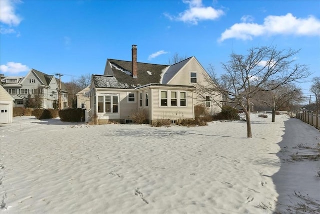 view of snow covered rear of property