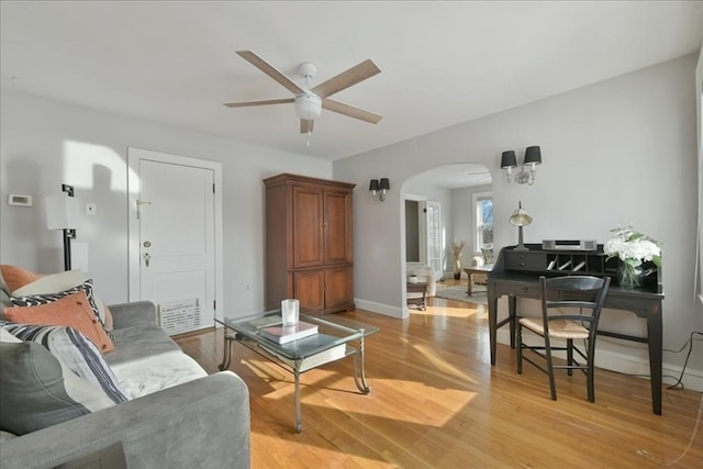 living room featuring ceiling fan and light hardwood / wood-style flooring