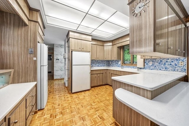 124 Mount Vernon Rd W, Weymouth, MA 02189 - kitchen featuring freestanding refrigerator, light countertops, a peninsula, and brown cabinets