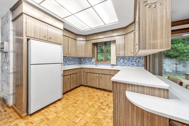 124 Mount Vernon Rd W, Weymouth, MA 02189 - kitchen with freestanding refrigerator, light countertops, wallpapered walls, and a peninsula