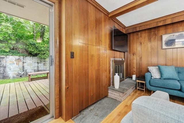 124 Mount Vernon Rd W, Weymouth, MA 02189 - living room featuring wood walls, wood finished floors, and a fireplace with raised hearth