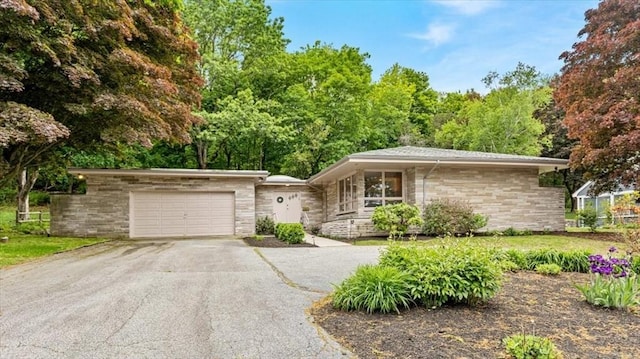 124 Mount Vernon Rd W, Weymouth, MA 02189 - view of front of home with asphalt driveway, a garage, and stone siding