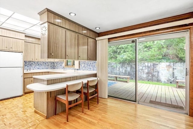 124 Mount Vernon Rd W, Weymouth, MA 02189 - kitchen with freestanding refrigerator, light countertops, a peninsula, and plenty of natural light