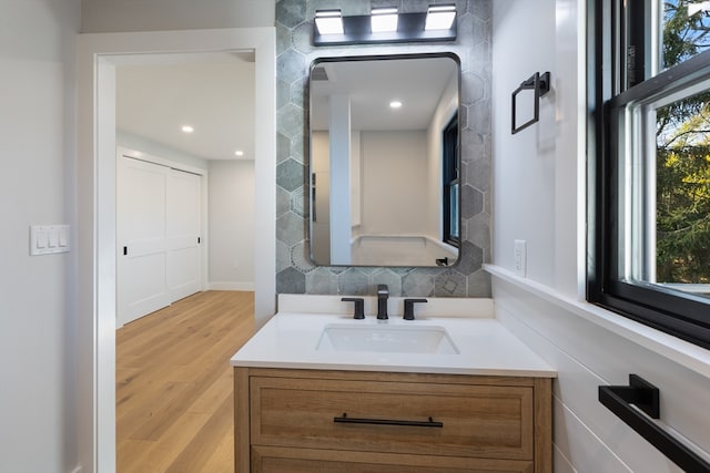 bathroom featuring backsplash, vanity, and hardwood / wood-style flooring