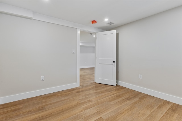 unfurnished room with light wood-type flooring