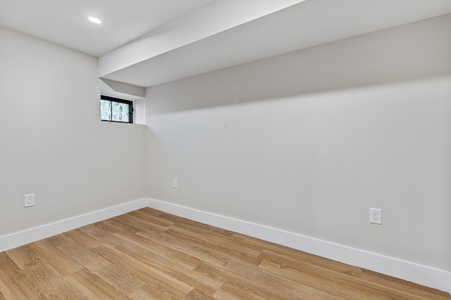 basement with hardwood / wood-style floors