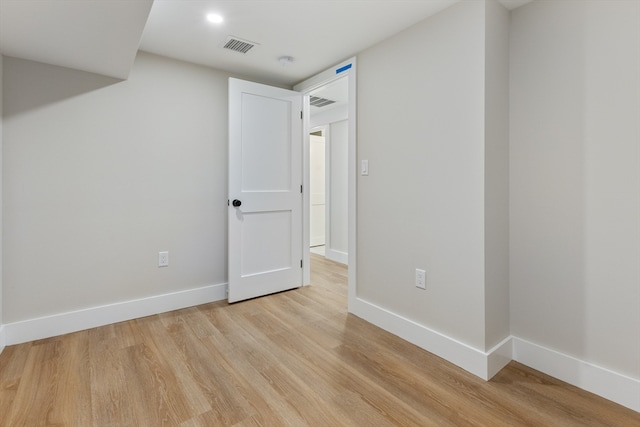 empty room with light hardwood / wood-style floors