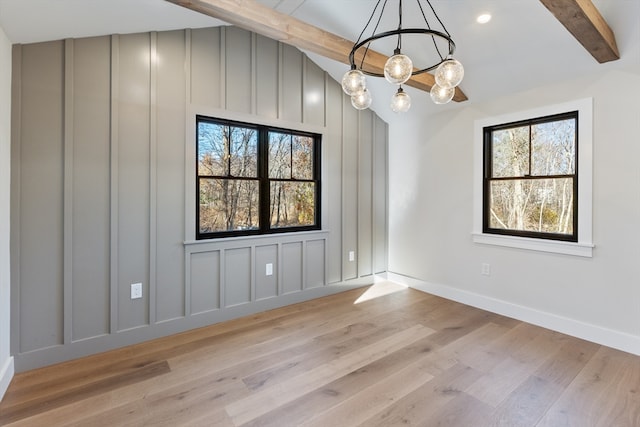 unfurnished dining area with vaulted ceiling with beams, light hardwood / wood-style flooring, and a notable chandelier