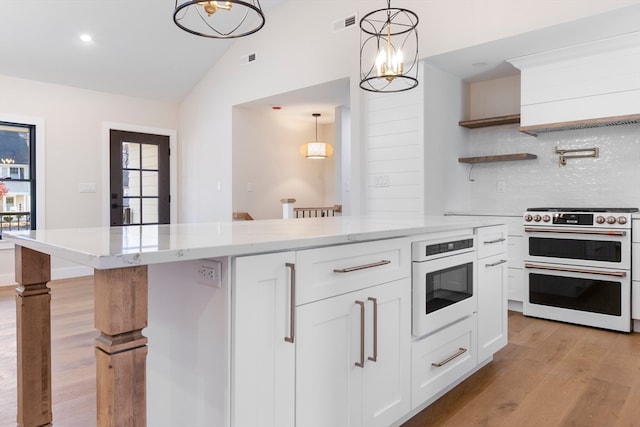 kitchen featuring white appliances, an inviting chandelier, decorative light fixtures, light hardwood / wood-style floors, and white cabinetry