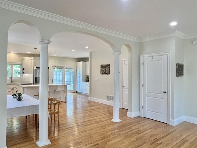 141 Pearl St Unit 141, Newton, MA 02458 - foyer with light wood finished floors, arched walkways, plenty of natural light, ornamental molding, and recessed lighting