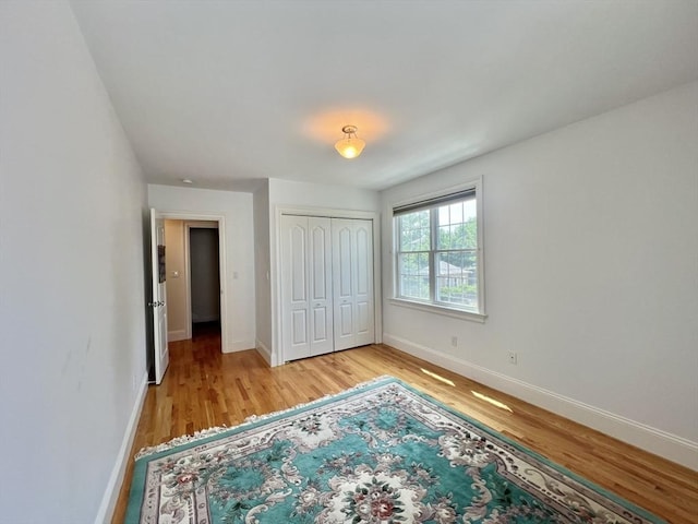 141 Pearl St Unit 141, Newton, MA 02458 - unfurnished bedroom featuring light wood-style floors and a closet
