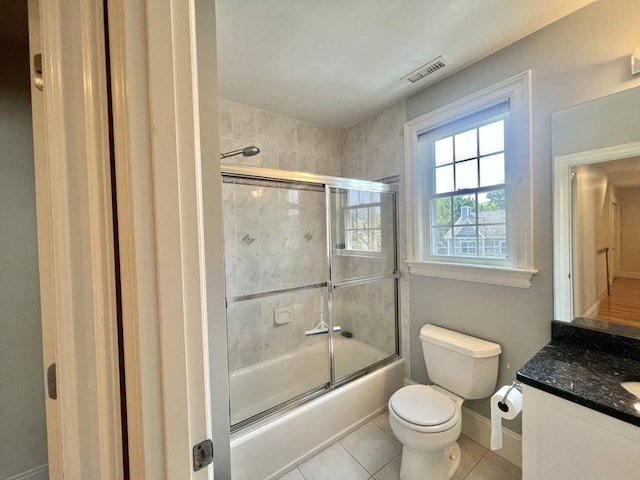141 Pearl St Unit 141, Newton, MA 02458 - bathroom featuring vanity, bath / shower combo with glass door, and tile patterned floors