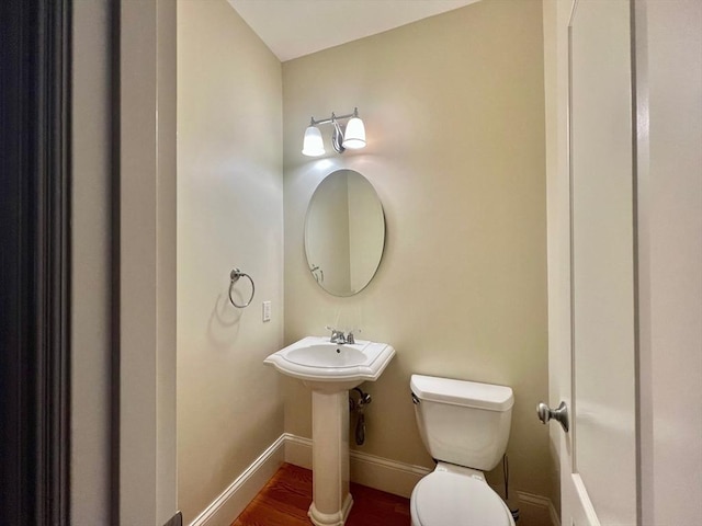 141 Pearl St Unit 141, Newton, MA 02458 - half bathroom featuring baseboards and wood finished floors