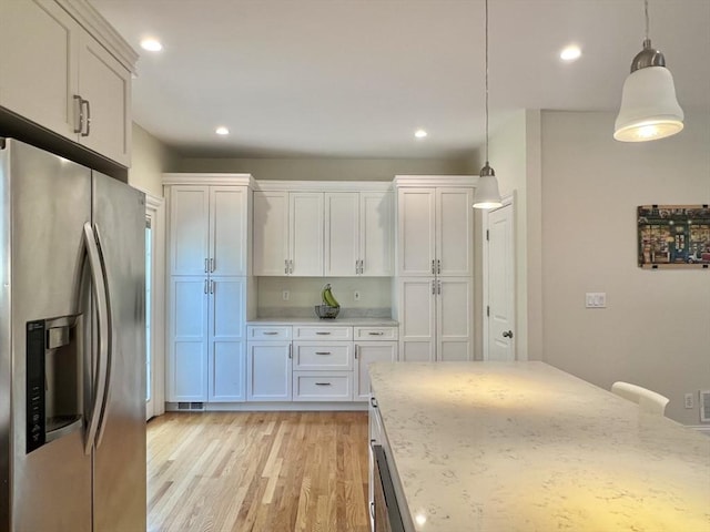 141 Pearl St Unit 141, Newton, MA 02458 - kitchen featuring stainless steel refrigerator with ice dispenser, light wood-type flooring, white cabinets, pendant lighting, and recessed lighting