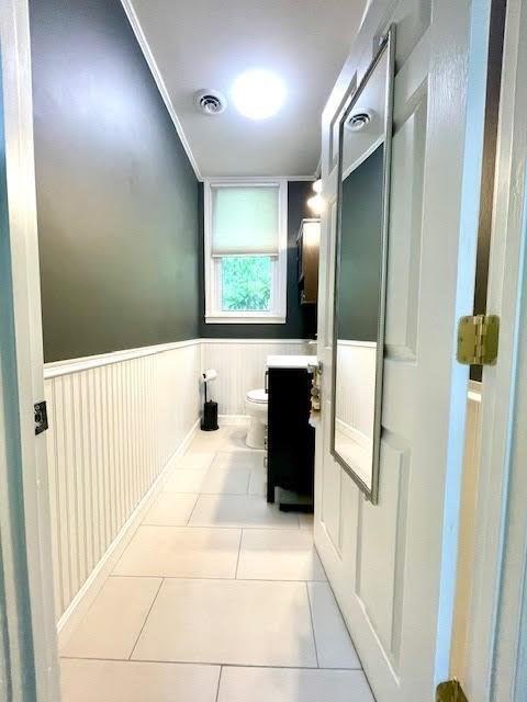 bathroom featuring tile patterned floors, vanity, and toilet