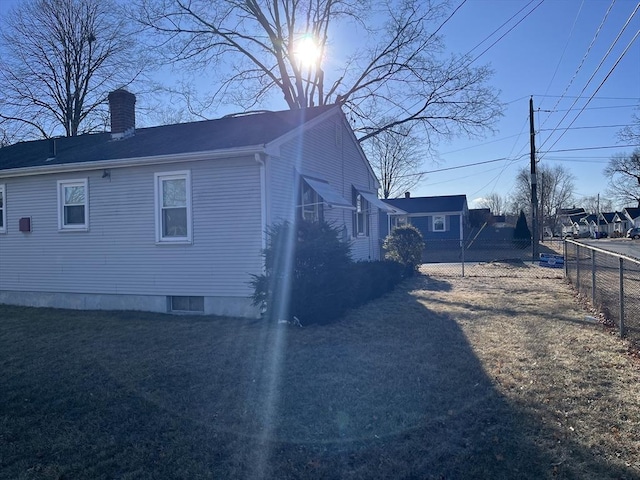 view of side of property with a lawn